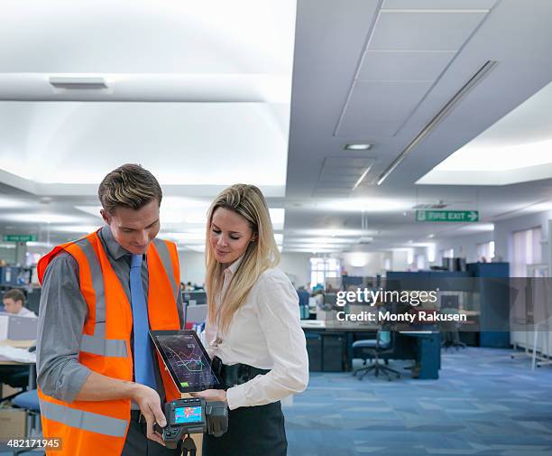 office workers looking at digital tablet and thermal infrared images in office - thermal imaging stock pictures, royalty-free photos & images
