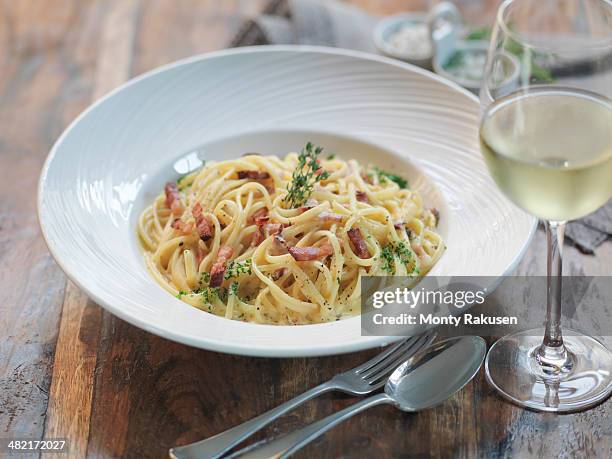 linguini carbonara made with smoked pancetta, fresh eggs, nutmeg, cream, parmesan cheese and black pepper - italien food stock pictures, royalty-free photos & images