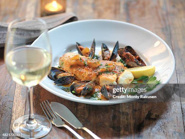 pan fried halibut with mussels, fresh fennel, garlic, chillies and tomato sauce - italien food stock pictures, royalty-free photos & images