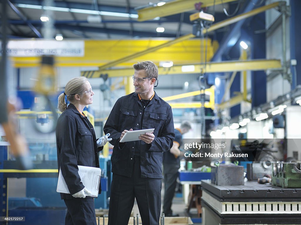 Workers in discussion in engineering factory