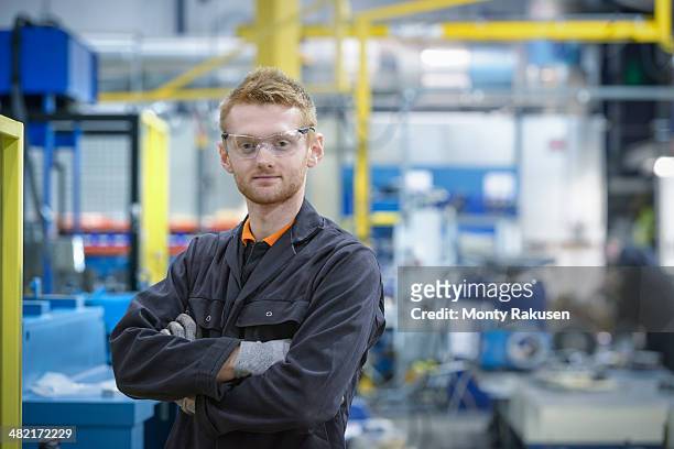 portrait of engineering apprentice in engineering factory - monty rakusen portrait stock pictures, royalty-free photos & images