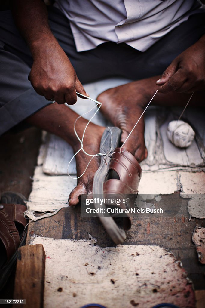 Close up of man repairing shoe