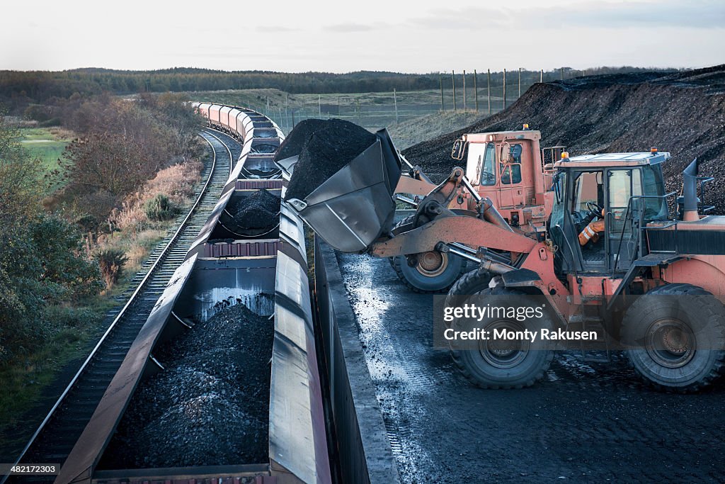 Diggers Loading Coal Onto Train At Surface Coal Mine At Dawn High-Res ...