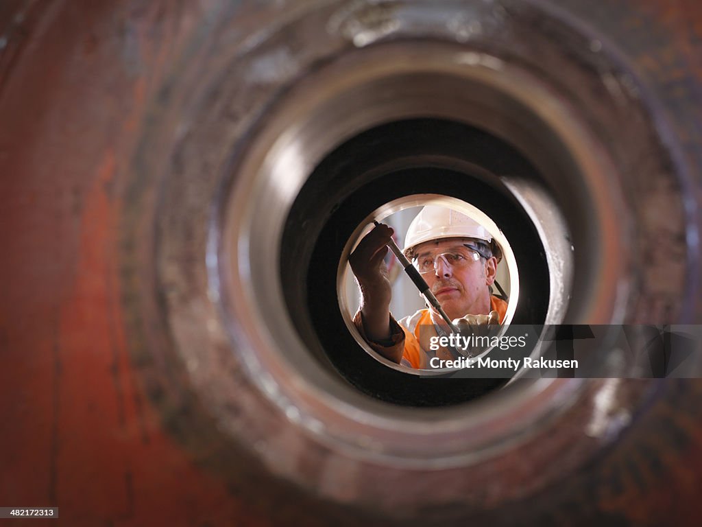 Engineer working on excavator parts in surface coal mine