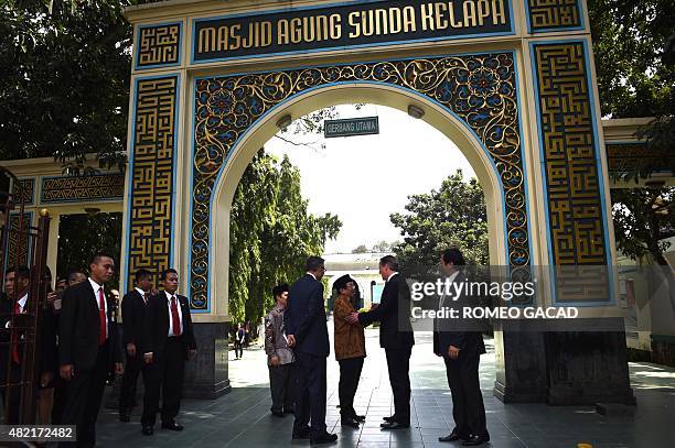 Britain's Prime Minister David Cameron shakes hands with Aksa Mahmud , the head of the religious board of Sunda Kelapa mosque, during his visit in...