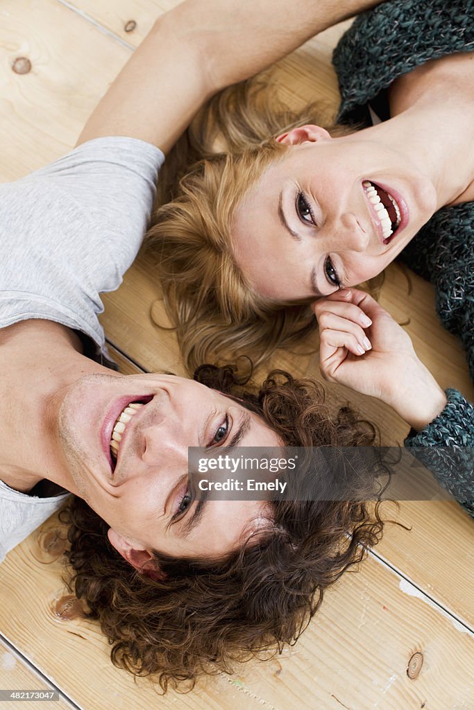 Studio shot couple lying on floor