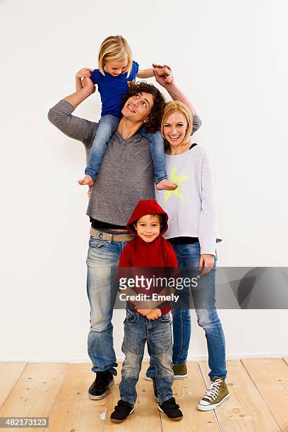 studio portrait of couple together with son and daughter - four people stock-fotos und bilder