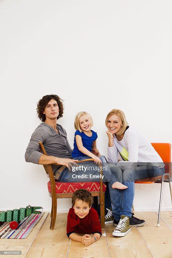 Studio portrait of couple sitting with son and daughter