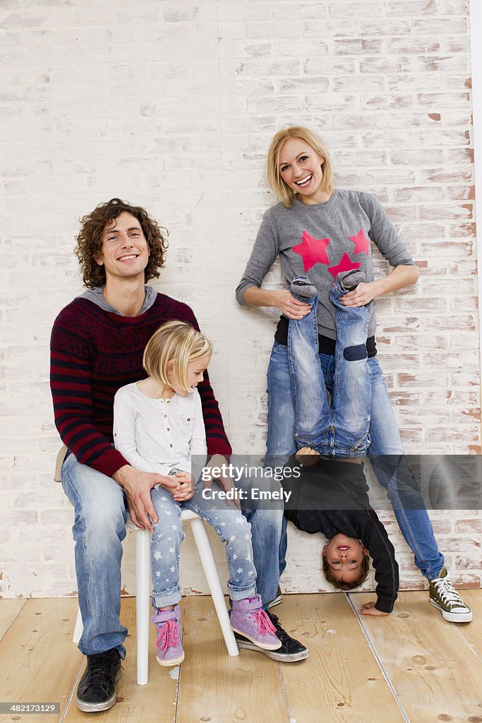 Studio portrait of couple waving fun with son and daughter