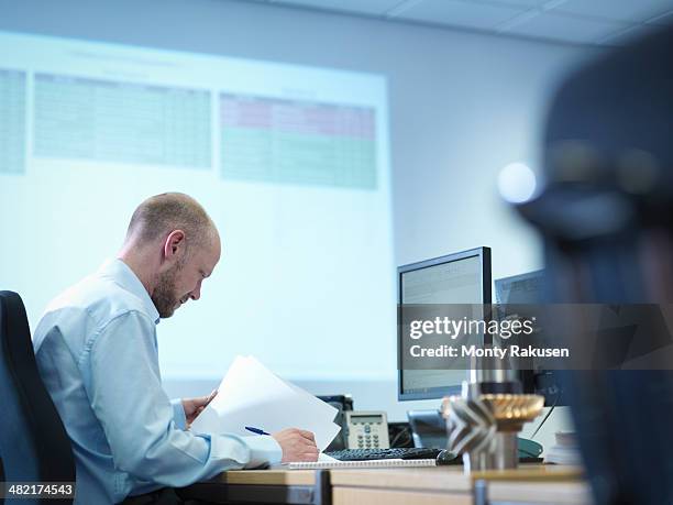 engineer using computer aided design in factory office - computer aided design stockfoto's en -beelden