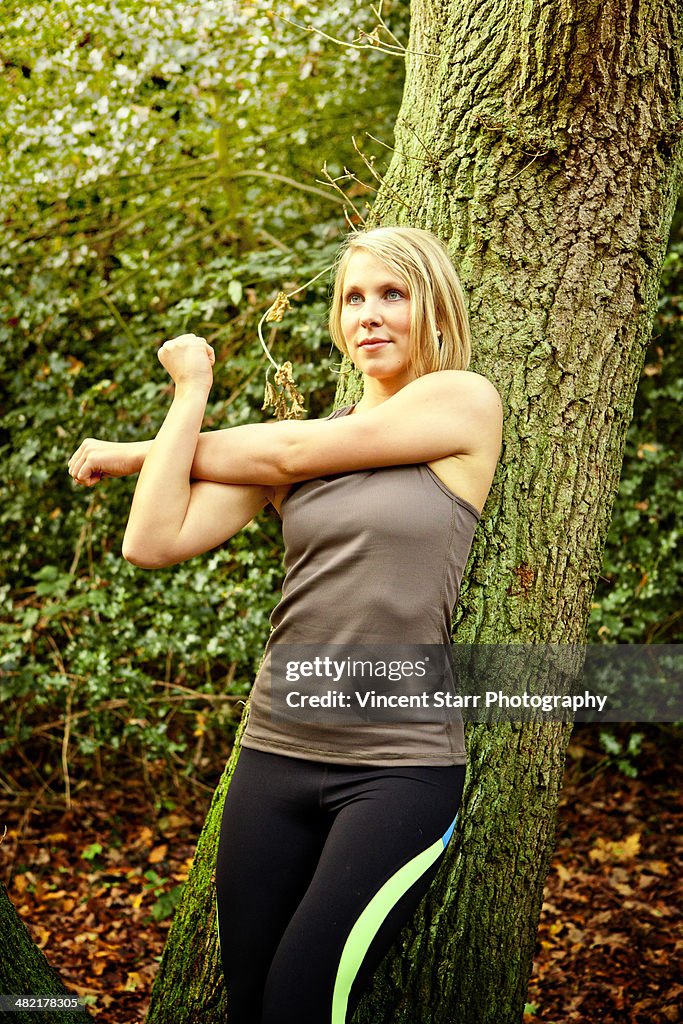 Woman stretching arms in woods