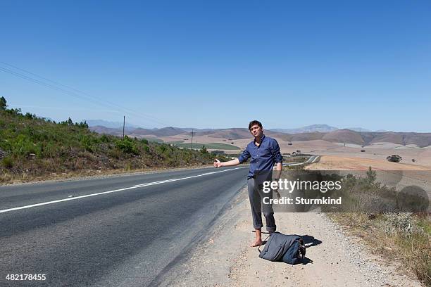 hitchhiker on side of road - hermanus stock pictures, royalty-free photos & images