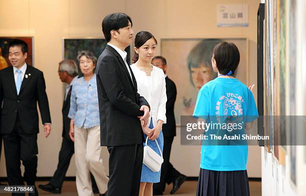 Prince Akishino and his second daughter Princess Kako watch exhibits during the Inter-High School Cultural Festival at Shiga Prefecture Museum of...