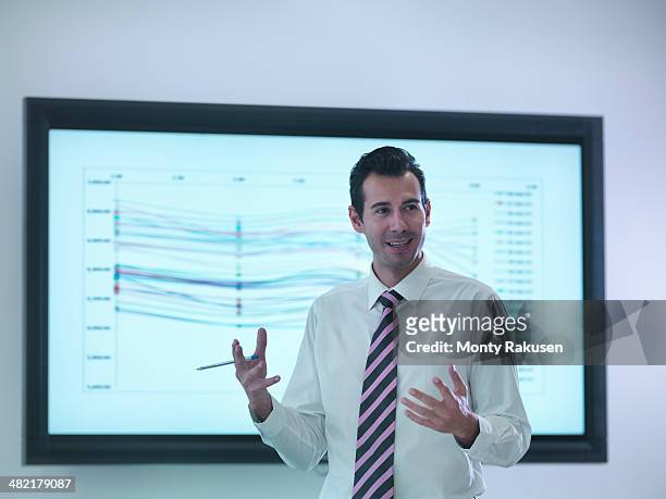 businessman making presentation in front of screen - south ruislip stock pictures, royalty-free photos & images