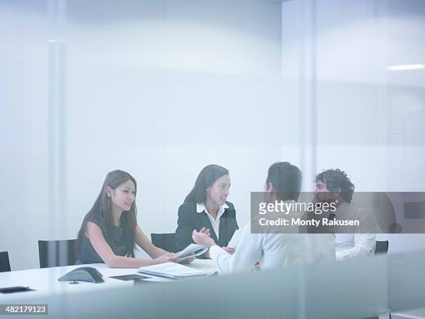 view through glass wall of business colleagues in meeting - south ruislip stock pictures, royalty-free photos & images