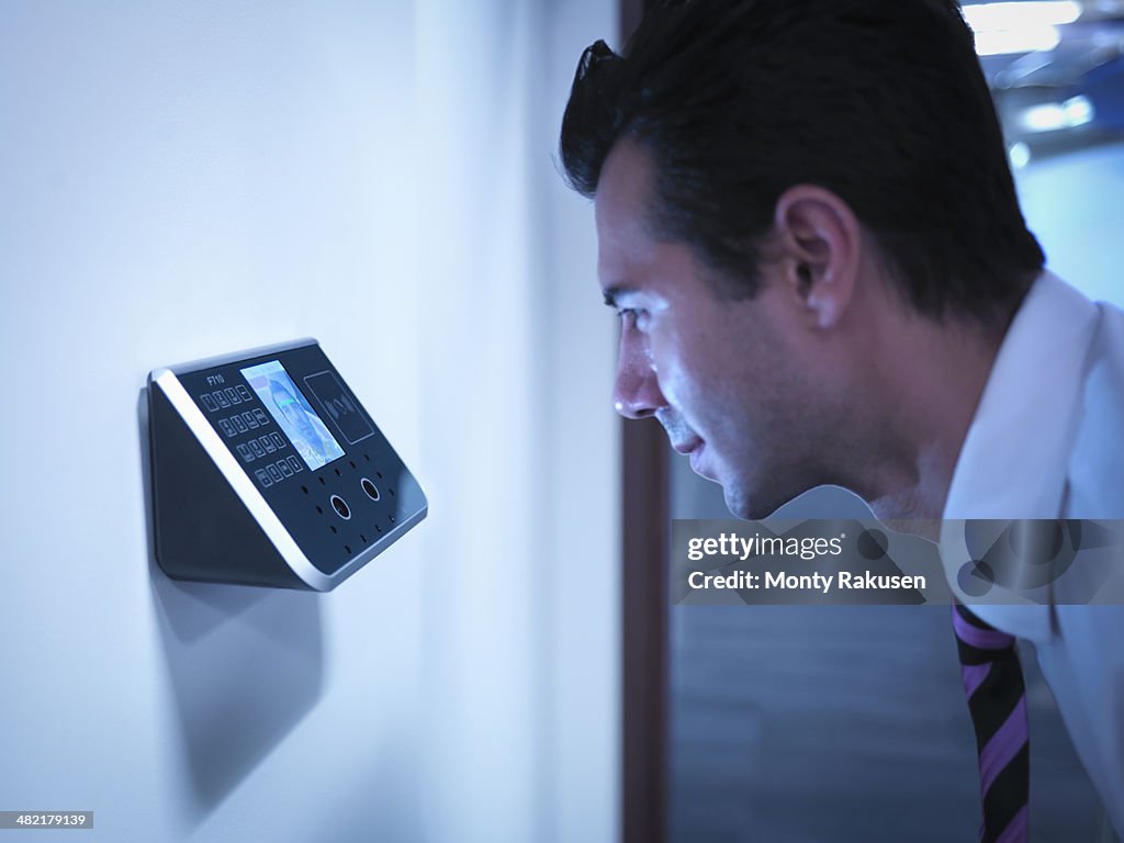 Businessman using face recognition system for office security