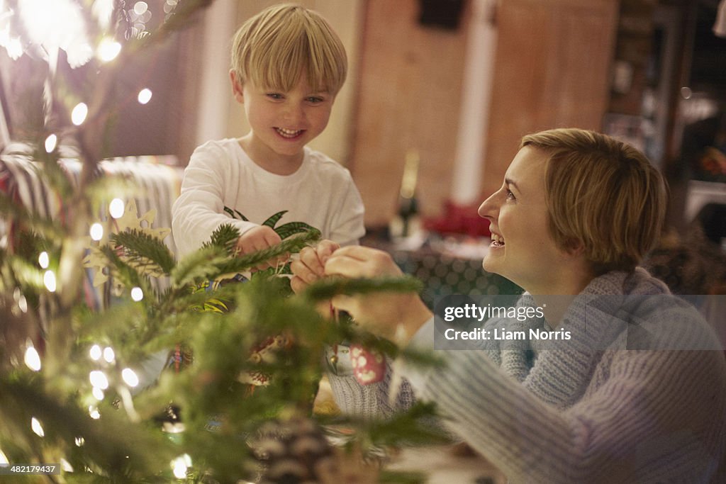 Mother and son decorating christmas tree