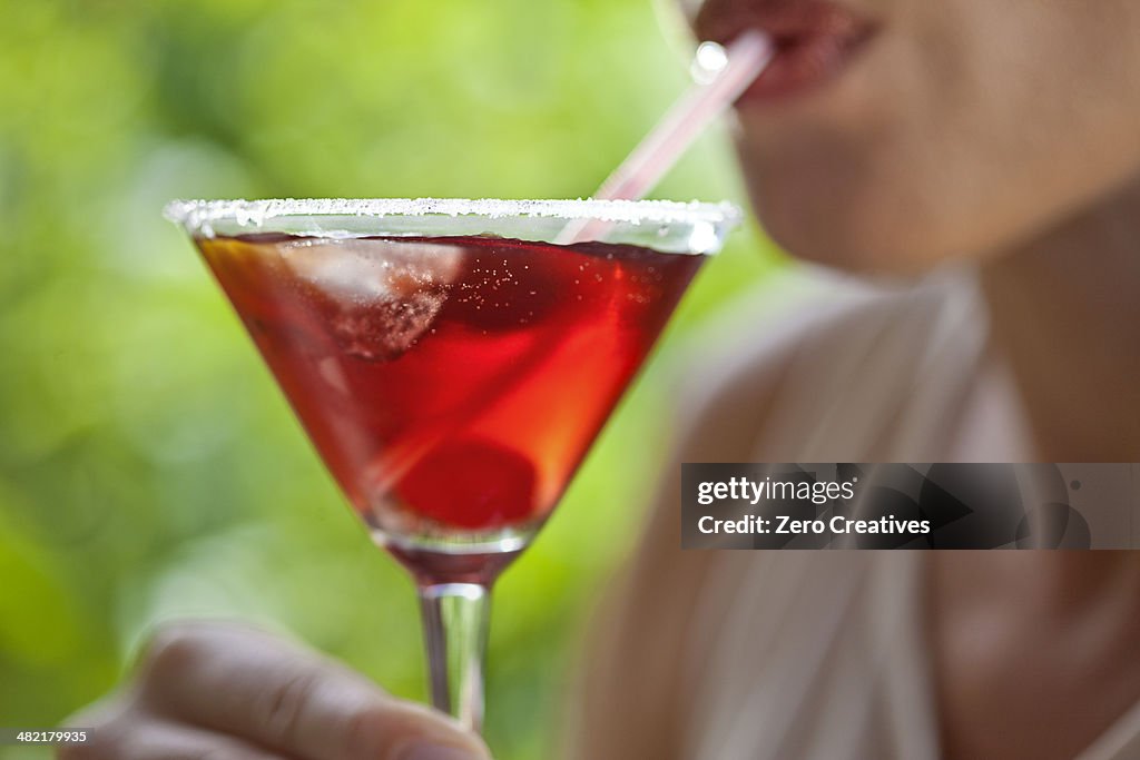 Woman sipping cocktail