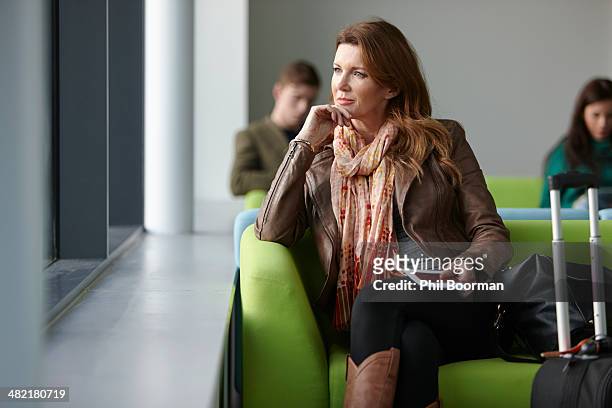 mature woman in departure lounge - portraits of people passport fotografías e imágenes de stock