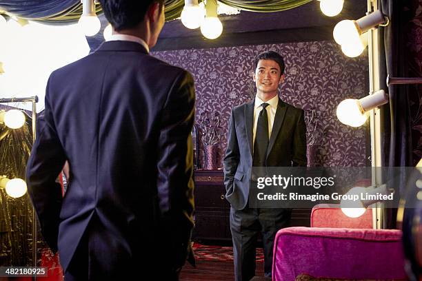 young male client trying on new suit in traditional tailors shop - tailored suit stock pictures, royalty-free photos & images