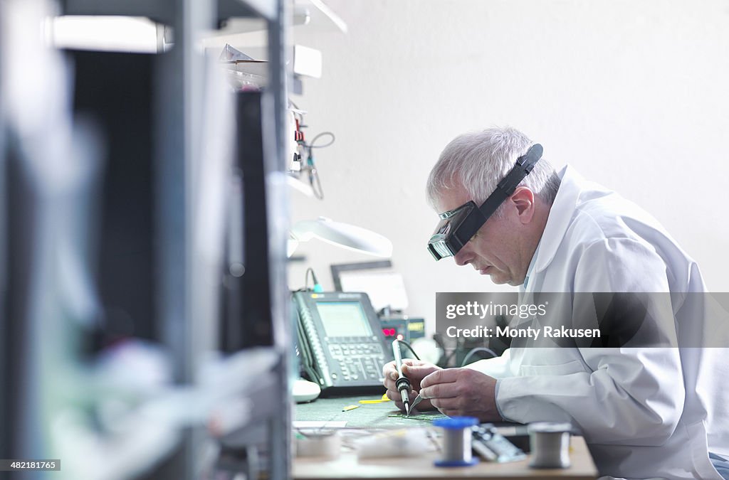 Engineer soldering prototype circuit board