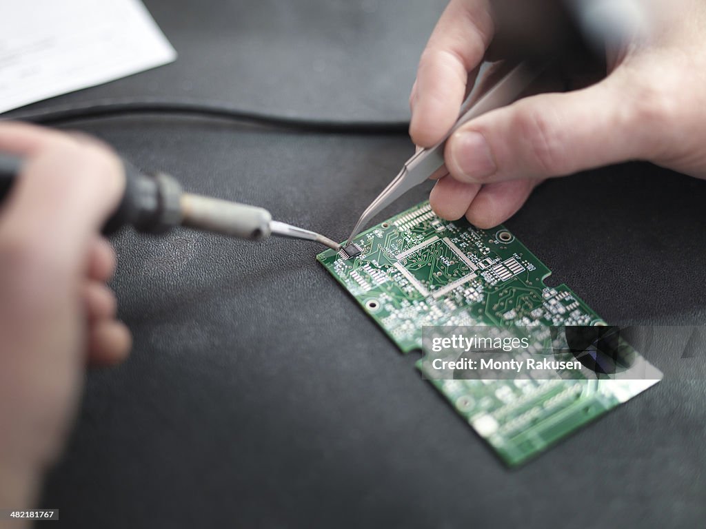 Close up of engineer soldering prototype circuit board