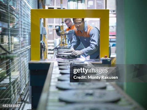 Workers on production line in industrial clutch factory Workers on production line in industrial clutch factory