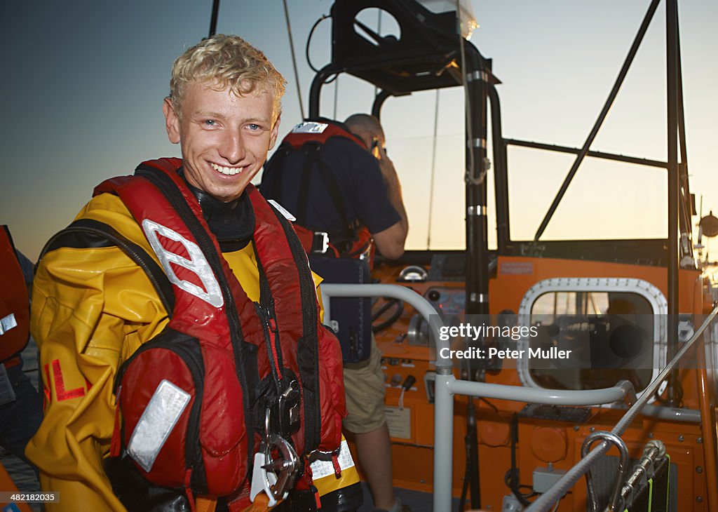Portrait of young man crewing lifeboat at sea