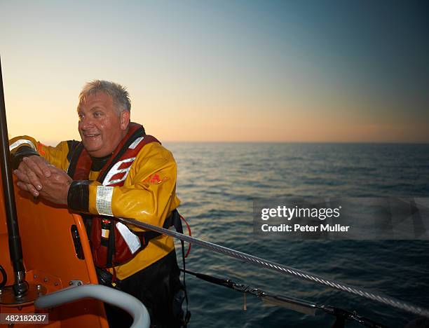 portrait of mature man crewing lifeboat at sea - lifeboat - fotografias e filmes do acervo