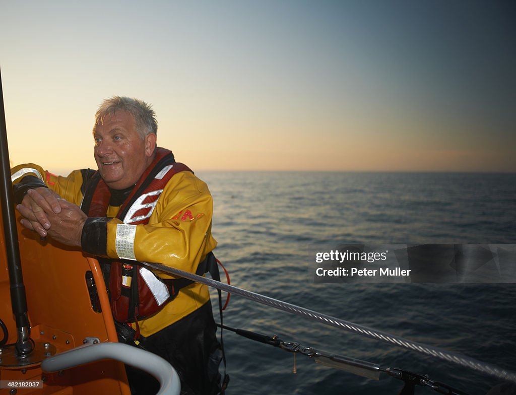 Portrait of mature man crewing lifeboat at sea