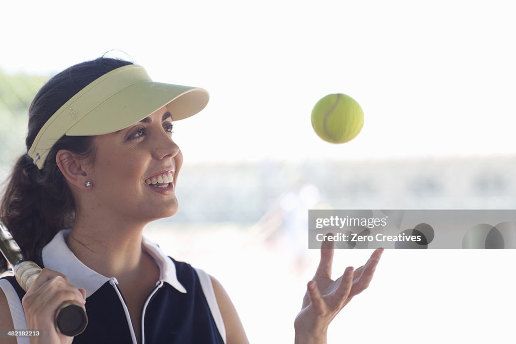Tennis player tossing ball