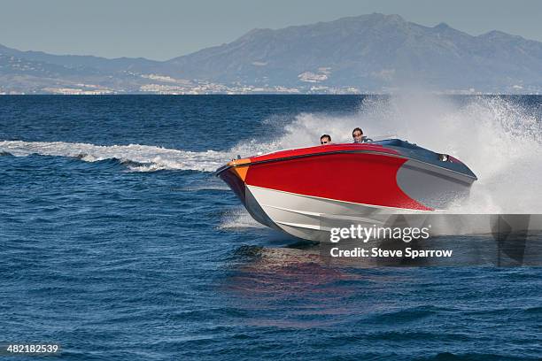 two adult men having fun in speedboat, sotogrande, cadiz, spain - speedboat foto e immagini stock