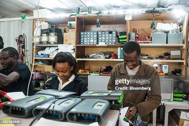 Emplyoees assemble electronic units used in pay-as-you-go solar powered lighting systems at the headquarters of M-Kopa Solar in Nairobi, Kenya, on...