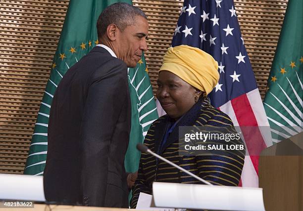 African Union Chairperson Nkosazana Dlamini Zuma leaves the stage as US President Barack Obama arrives to deliver a speech at the African Union...
