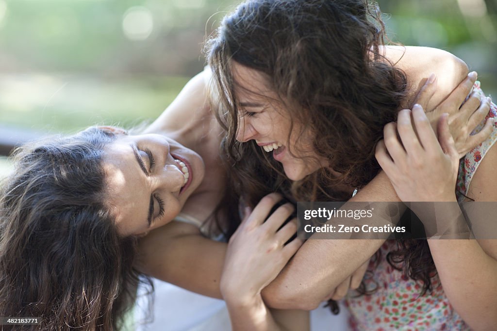 Young female friends enjoying playfight