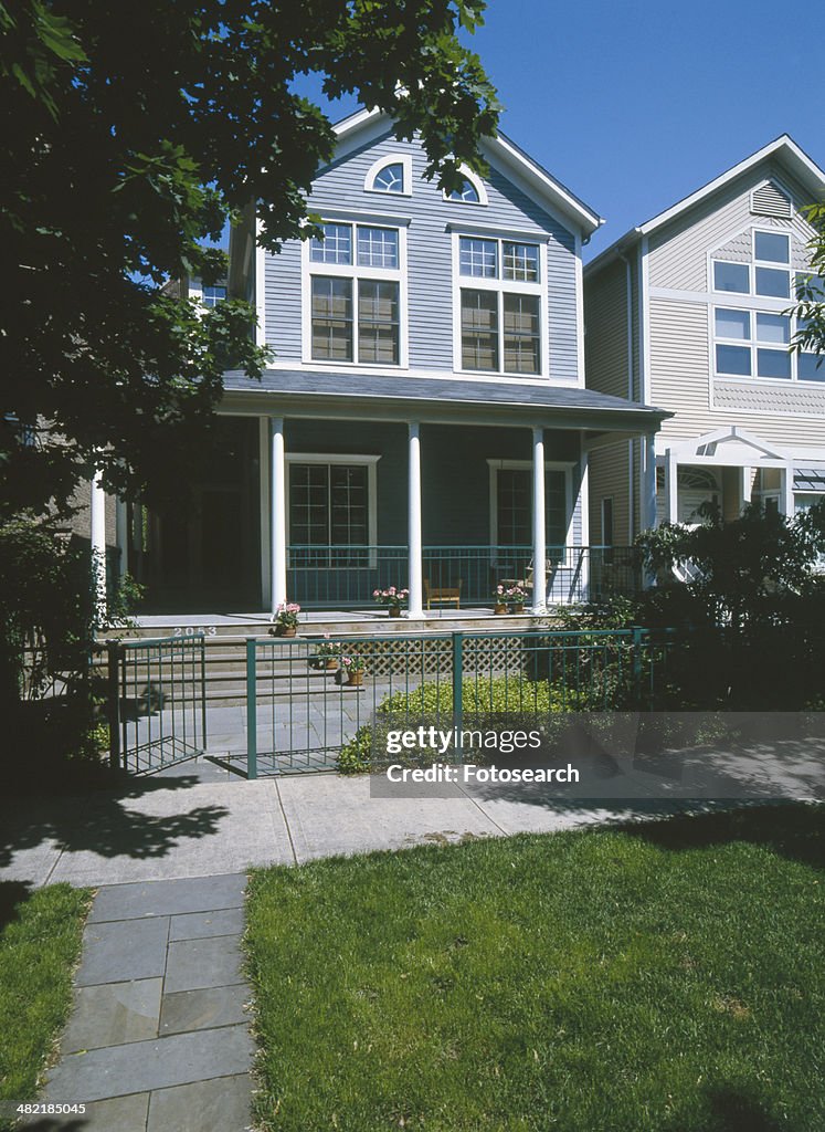 Facade of blue gray bungalow with white trim