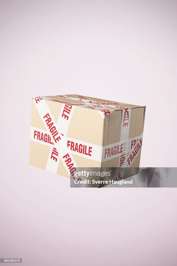 Studio shot of cardboard box marked fragile