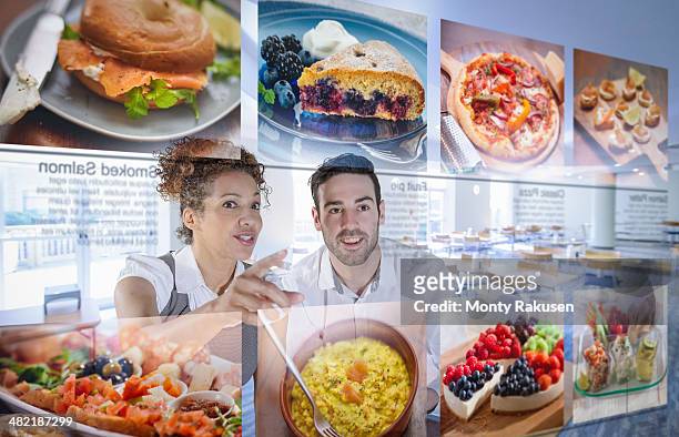 Customers choosing food from interactive display in office canteen