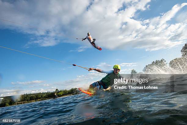 Wakeboarder Moritz Petri and Cedric Schmidt with the Kneeboard perform during a training session at 'Hotspot Seepark' on July 27, 2015 in...