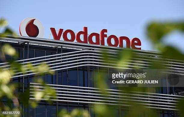 Picture taken on on July 28, 2015 shows the logo of British telecom giant Vodafone atop the Spanish headquarters in Madrid. British telecom giant...