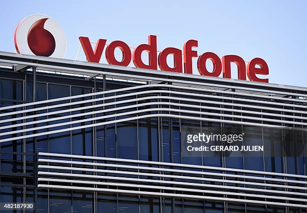 Picture taken on on July 28, 2015 shows the logo of British telecom giant Vodafone atop the Spanish headquarters in Madrid. British telecom giant...