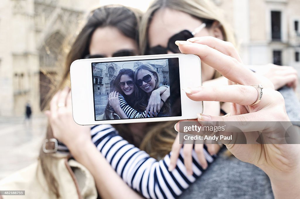 Two young female friends taking a self portrait, Valencia, Spain