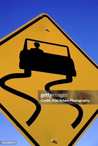 sign warning of slippery road - slippery road sign stock pictures, royalty-free photos & images