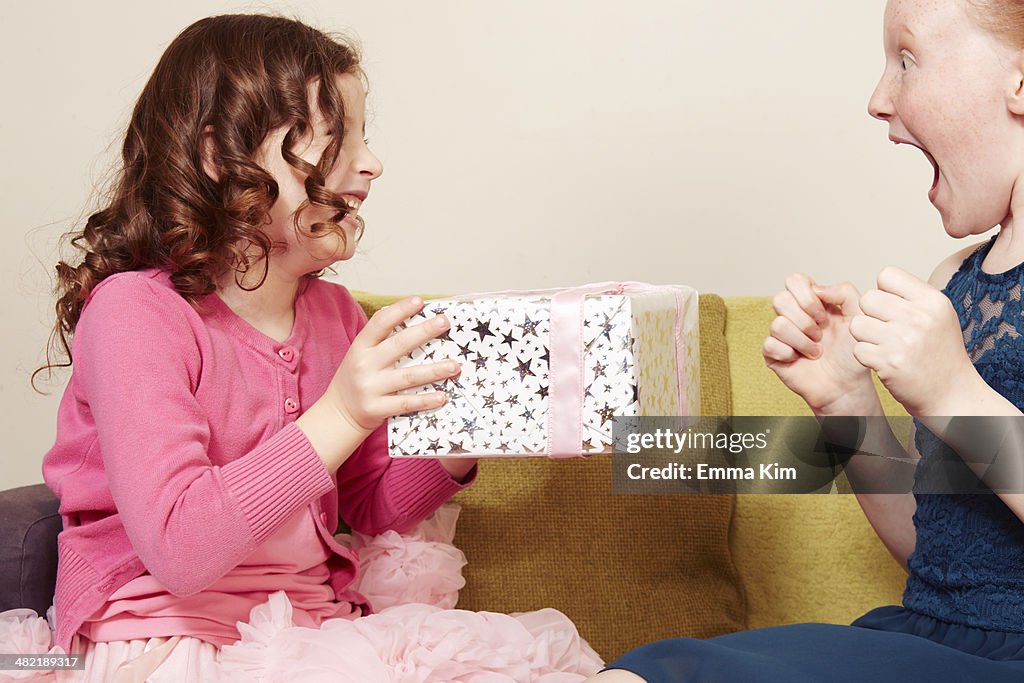 Girl giving friend birthday present