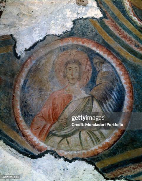 Italy, Lombardy, Pavia, Church of Saint John Domnarum. Detail. Fragment of a fresco with bust of an archange in a round frame on a blue background.