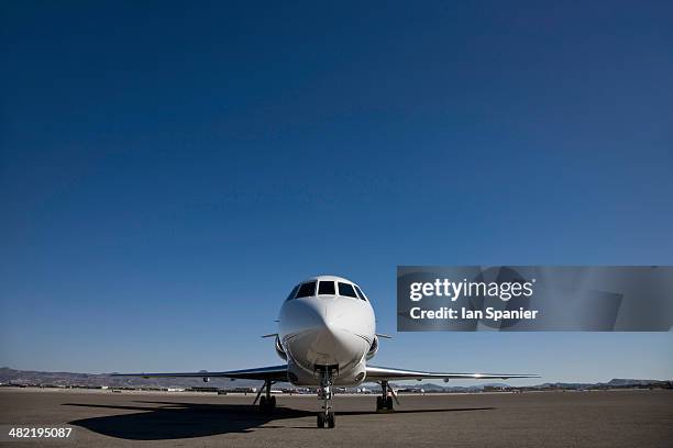 stationary private jet on airfield tarmac - plane front view stock pictures, royalty-free photos & images