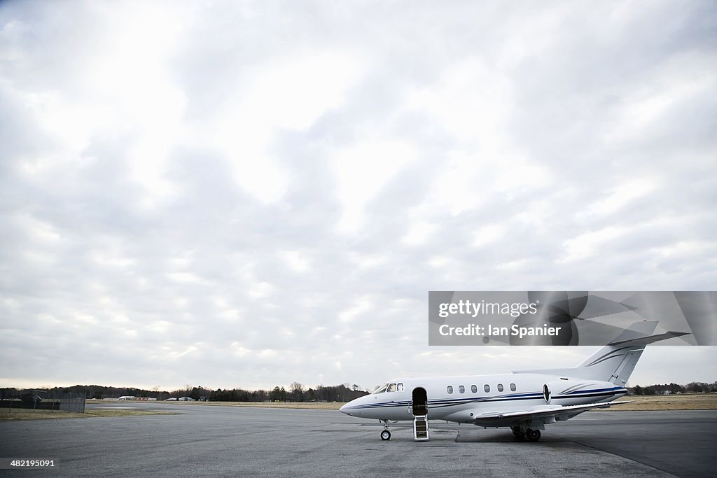 Stationary private jet on airport runway