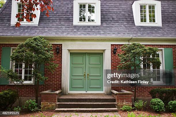 cropped full frame view of house exterior - man at front door stock-fotos und bilder