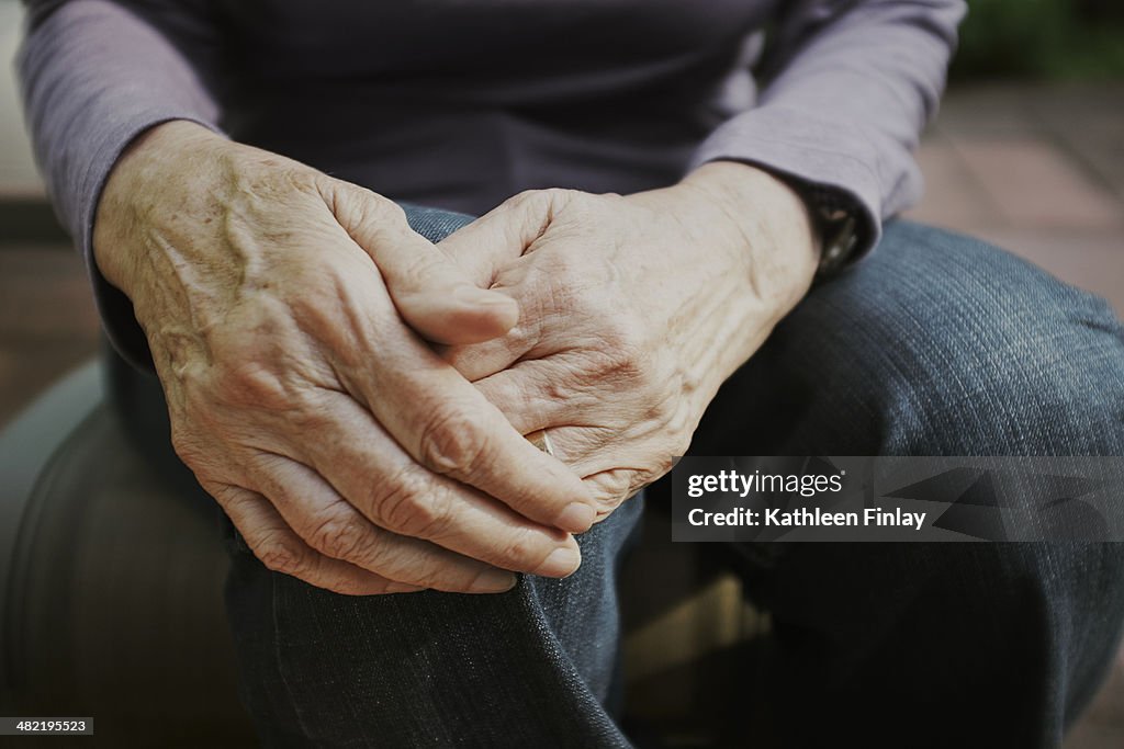 Cropped shot of senior woman with hands on knee