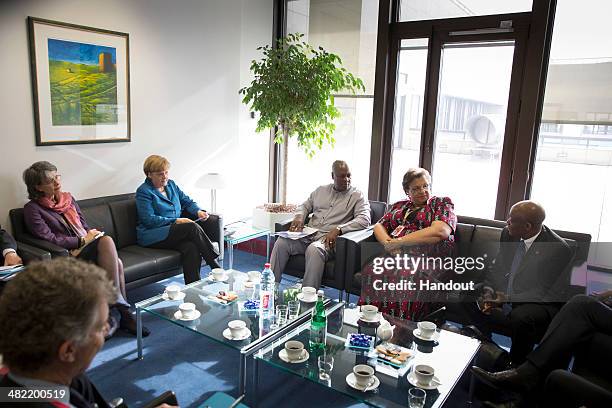 In this handout photo provided by the German Government Press Office German Chancellor Angela Merkel meets with President of Ghana John Dramani...